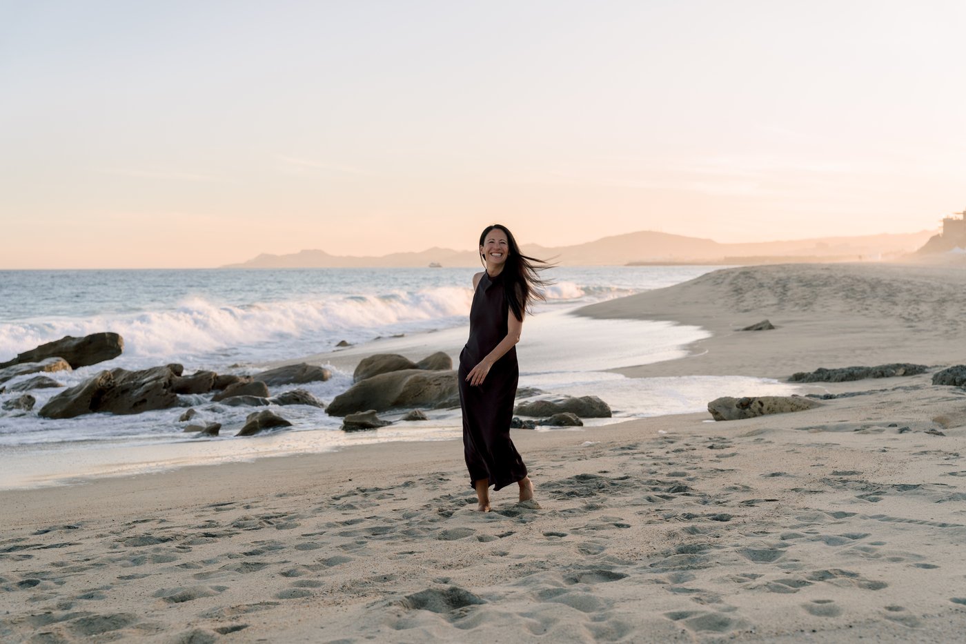 Lisa Axford walking the beach at sunset