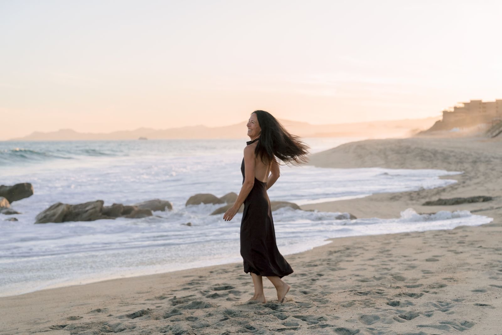 Lisa Axford walking on the beach at sunset